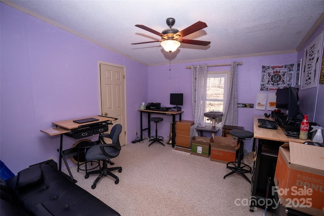 home office featuring a textured ceiling, ornamental molding, carpet flooring, and a ceiling fan