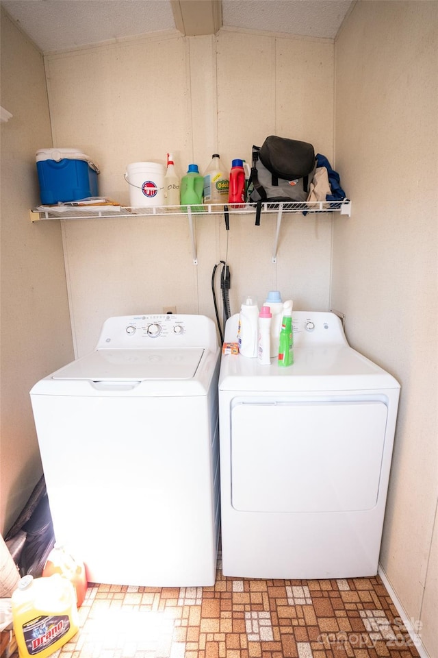 laundry room featuring laundry area, brick patterned floor, and independent washer and dryer