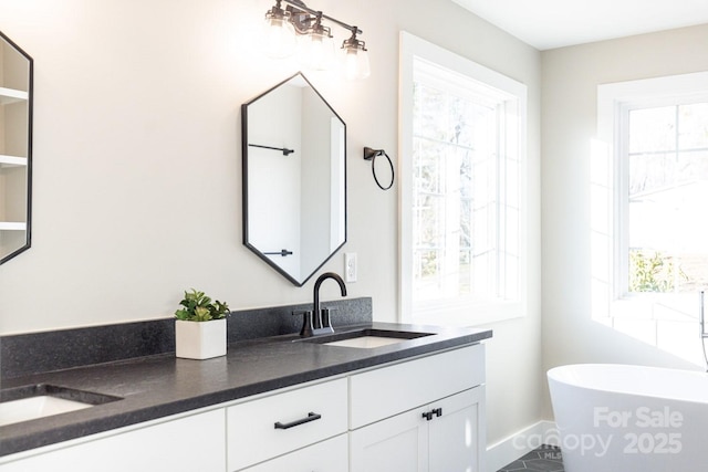 bathroom featuring double vanity, a soaking tub, and a sink