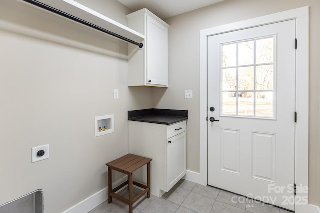 clothes washing area featuring light tile patterned floors, hookup for a washing machine, cabinet space, electric dryer hookup, and baseboards