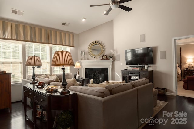 living room featuring high vaulted ceiling, dark wood-type flooring, and ceiling fan