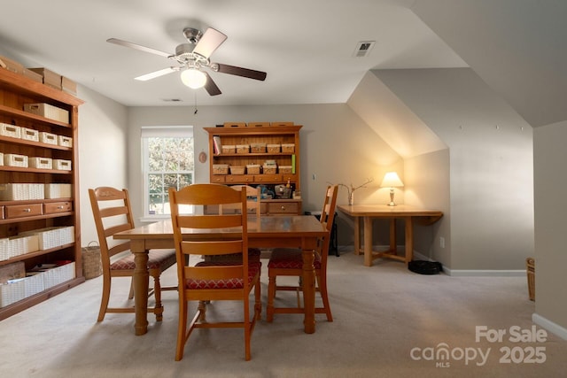 carpeted dining space with ceiling fan