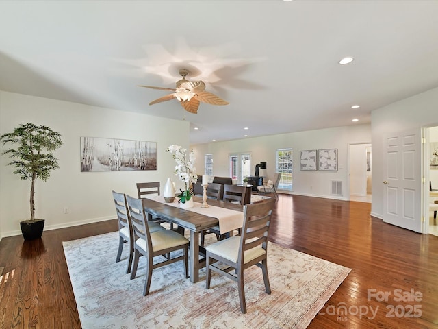 dining space with dark hardwood / wood-style flooring and ceiling fan