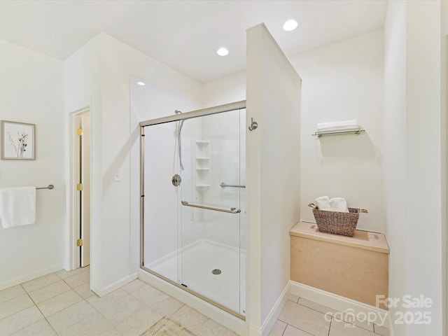 bathroom featuring a shower with door and tile patterned flooring