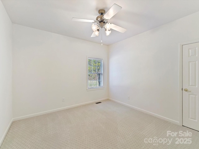 unfurnished room featuring light carpet and ceiling fan