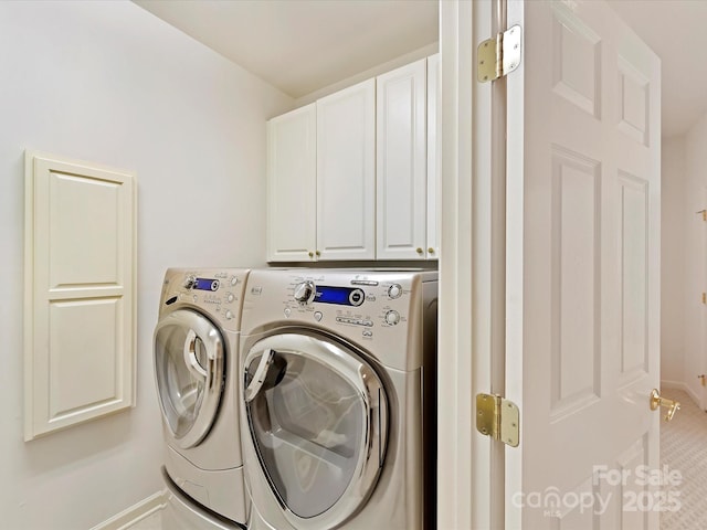 laundry room with independent washer and dryer and cabinets