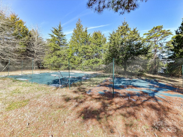 view of pool featuring tennis court