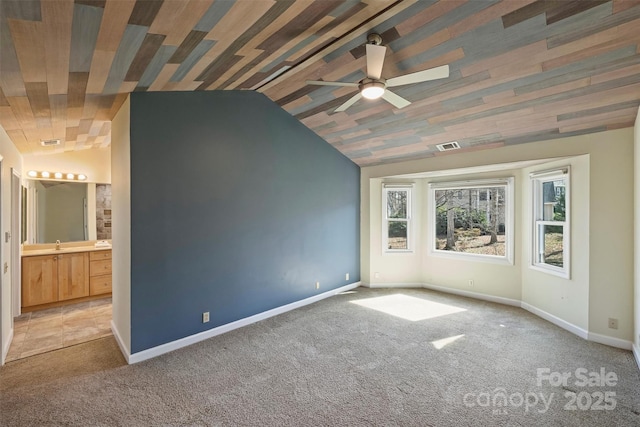 spare room with sink, light carpet, vaulted ceiling, and ceiling fan