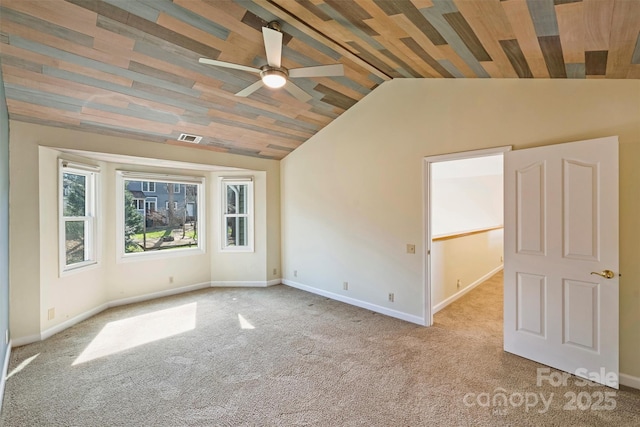 empty room with lofted ceiling, ceiling fan, and light colored carpet