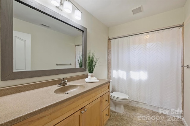 bathroom featuring toilet and vanity