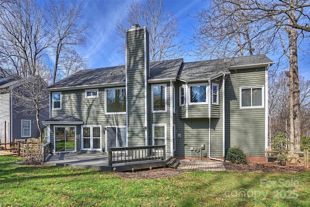 back of property featuring a deck, a yard, and a patio area