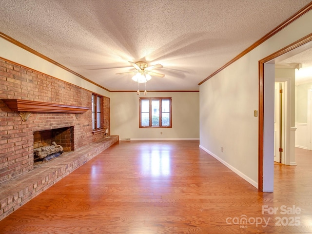 unfurnished living room featuring hardwood / wood-style floors, a brick fireplace, and a textured ceiling