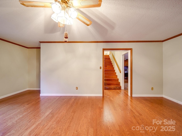 unfurnished room with crown molding, a textured ceiling, ceiling fan, and light wood-type flooring