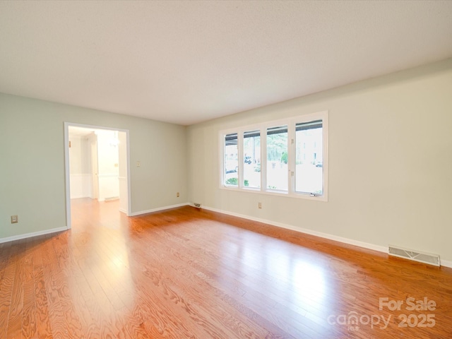 unfurnished room with light hardwood / wood-style flooring