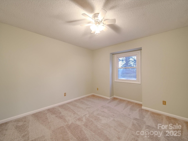 carpeted spare room with ceiling fan and a textured ceiling