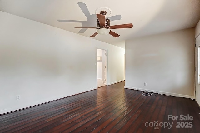 spare room with dark wood-type flooring and ceiling fan