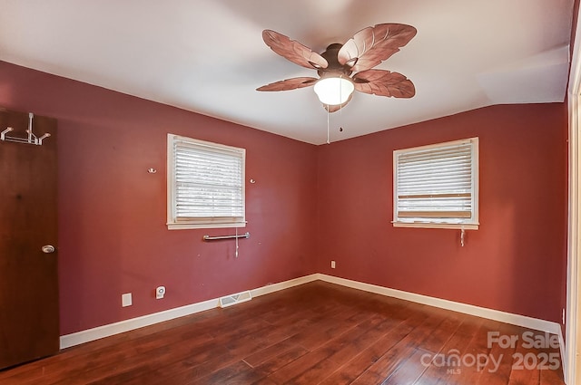 empty room featuring hardwood / wood-style flooring, lofted ceiling, and ceiling fan