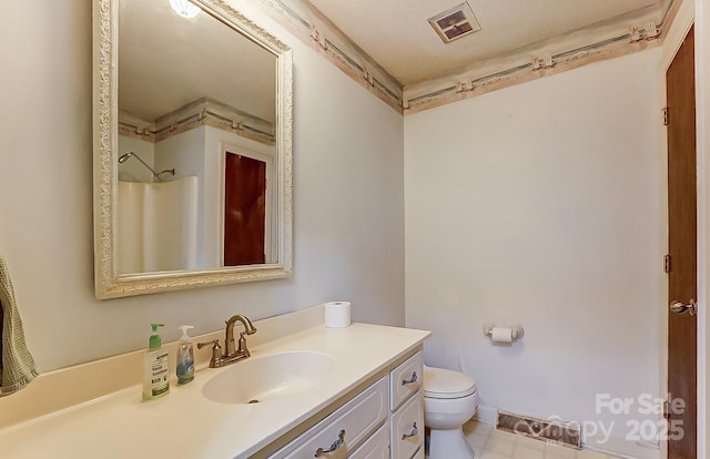 bathroom with vanity, a shower, and toilet