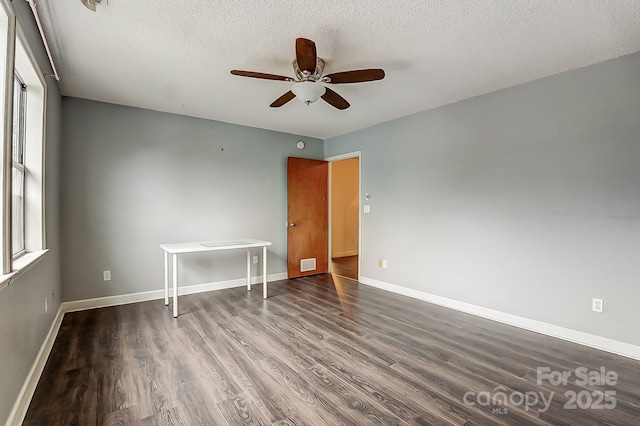 empty room featuring ceiling fan, wood-type flooring, and a textured ceiling