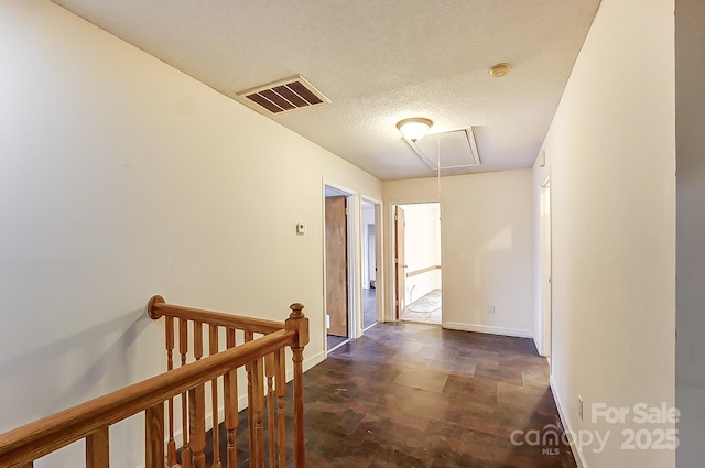 hallway with a textured ceiling