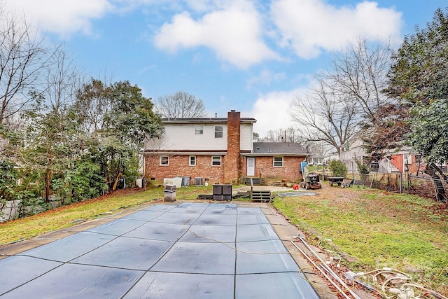 rear view of house with a lawn