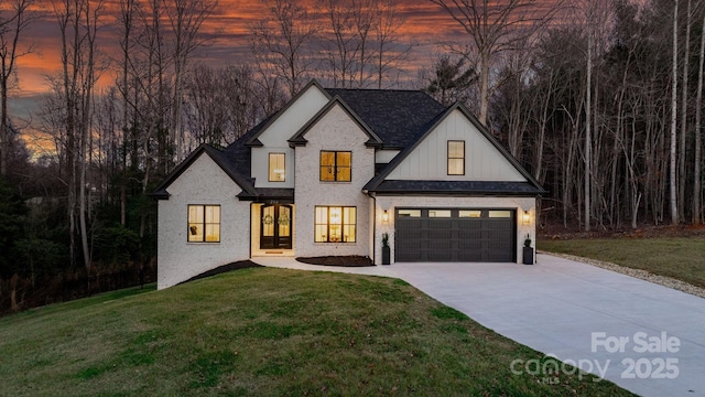 modern inspired farmhouse featuring driveway, a garage, a lawn, board and batten siding, and brick siding