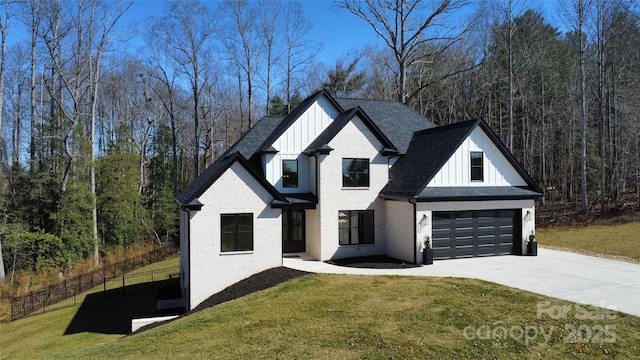 modern inspired farmhouse with a shingled roof, concrete driveway, a front yard, board and batten siding, and brick siding