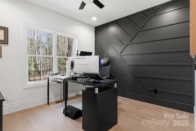 office space with ceiling fan, recessed lighting, a decorative wall, light wood-style floors, and baseboards