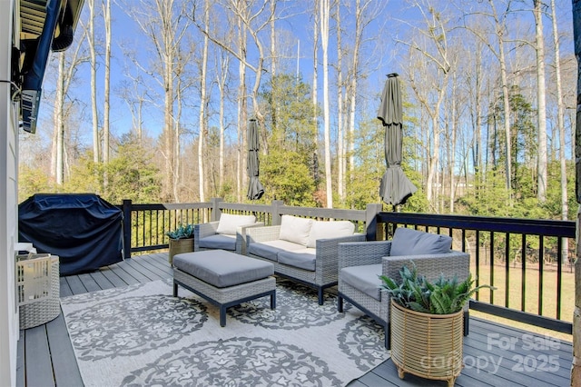 wooden deck with grilling area and an outdoor living space