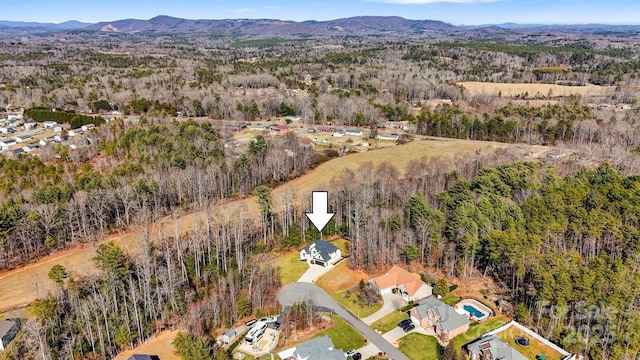 aerial view featuring a mountain view and a view of trees