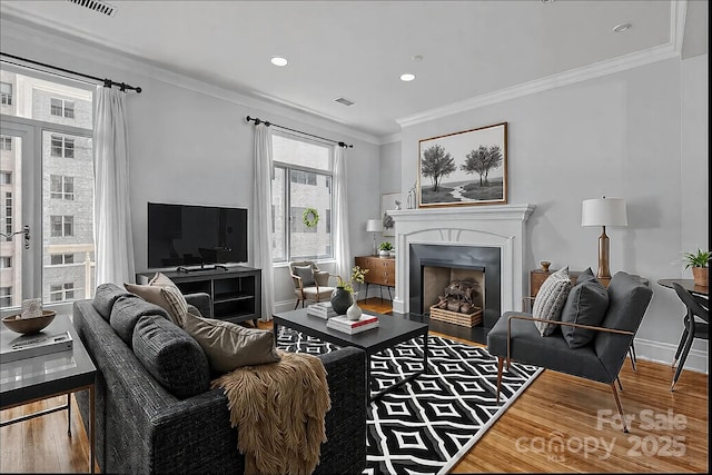 living room featuring crown molding and wood-type flooring