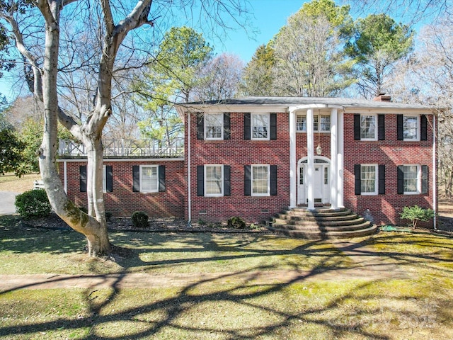 greek revival inspired property with crawl space, a front lawn, and brick siding