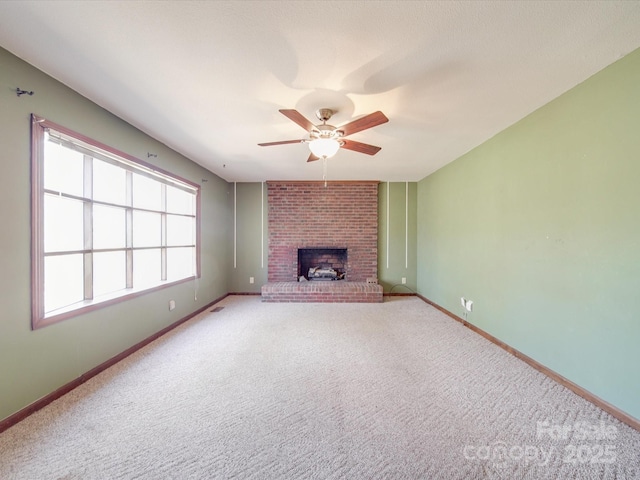 unfurnished living room featuring a fireplace, visible vents, a ceiling fan, light carpet, and baseboards