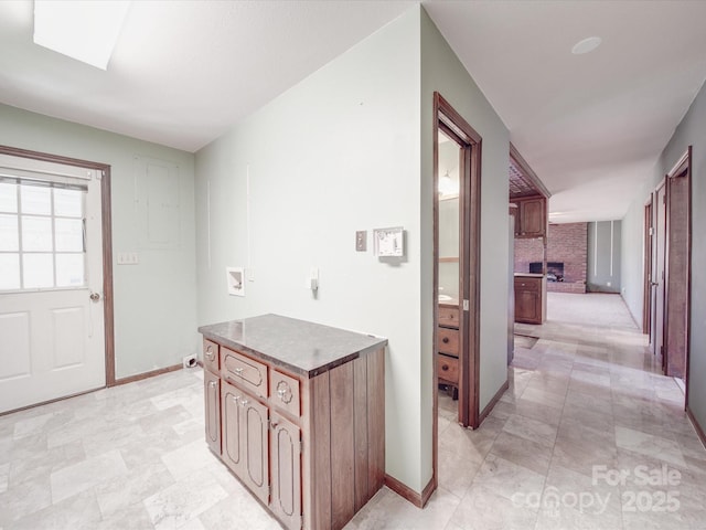 interior space with a skylight and baseboards