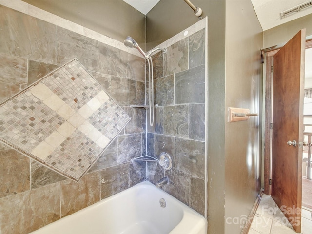 bathroom with tile patterned floors, visible vents, and bathing tub / shower combination