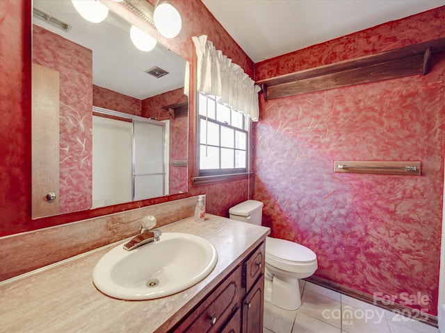 full bath with toilet, a shower with shower door, vanity, and visible vents