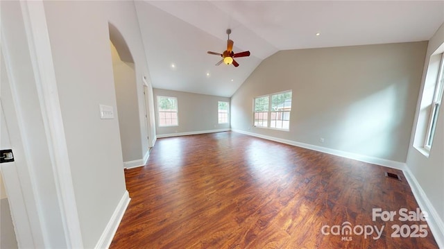 unfurnished room featuring dark wood-type flooring, ceiling fan, and vaulted ceiling