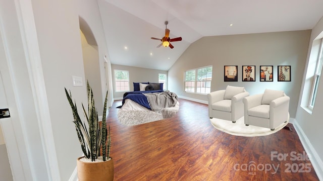 bedroom featuring dark hardwood / wood-style flooring, vaulted ceiling, and ceiling fan