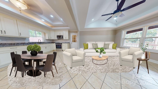 tiled living room featuring crown molding, sink, ceiling fan, and a tray ceiling