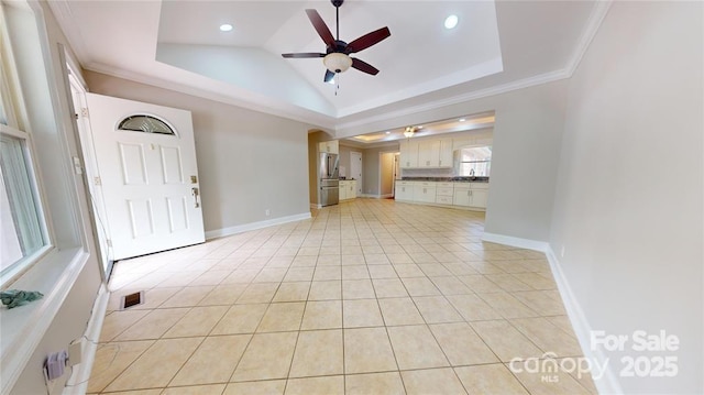 unfurnished living room featuring crown molding, light tile patterned floors, a tray ceiling, and ceiling fan