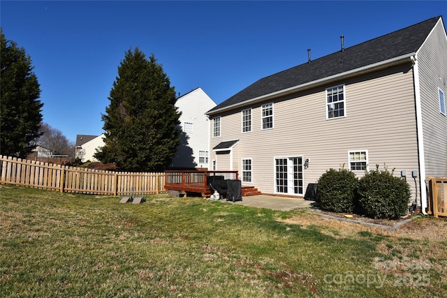 rear view of house with a lawn, a patio area, and a wooden deck