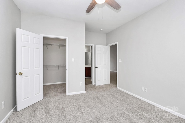 unfurnished bedroom featuring baseboards, ceiling fan, a spacious closet, carpet flooring, and a closet