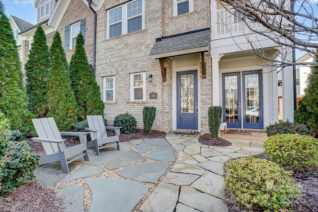 view of exterior entry featuring a patio area and french doors