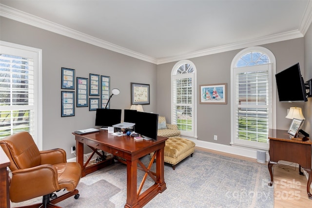 home office with a wealth of natural light, light hardwood / wood-style flooring, and crown molding