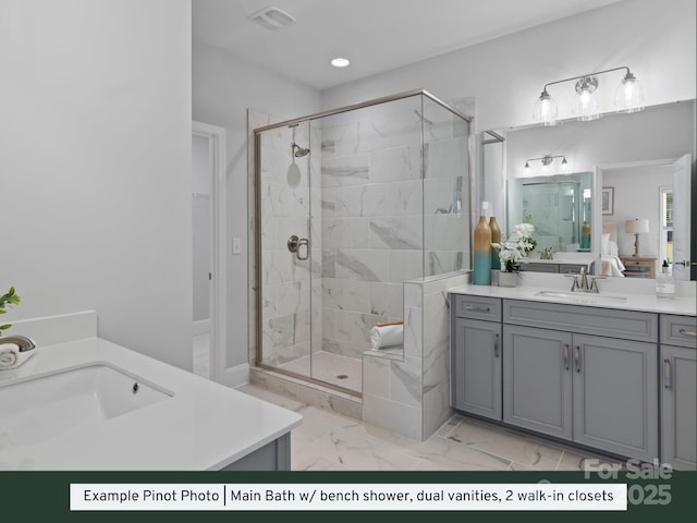 bathroom featuring two vanities, visible vents, a stall shower, and a sink