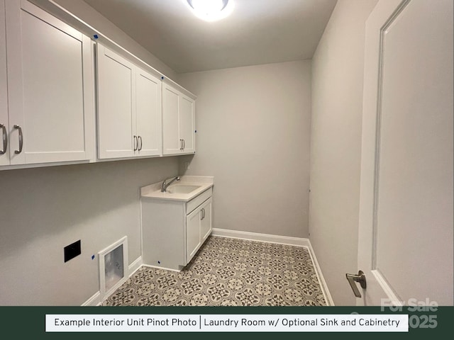 washroom with electric dryer hookup, cabinet space, baseboards, and a sink