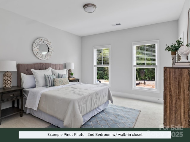 bedroom with light colored carpet and visible vents