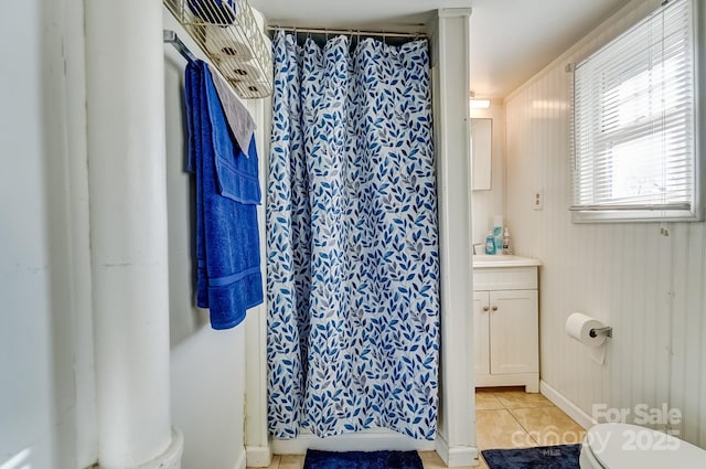 bathroom with tile patterned flooring, curtained shower, vanity, and toilet