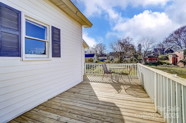 deck featuring a residential view and outdoor dining area