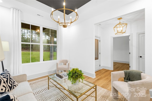 5147 Star Magnolia Ct, Clover, SC 29710 - living area featuring baseboards, visible vents, an inviting chandelier, and light wood-style floors